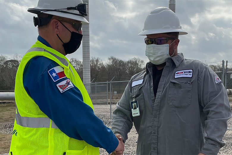 Two men shaking hands on industrial job site. WT Rail is a Railroad Scale certification and calibration company .